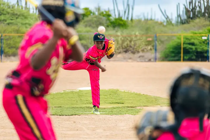 Pitcher in pink delivering a pitch
